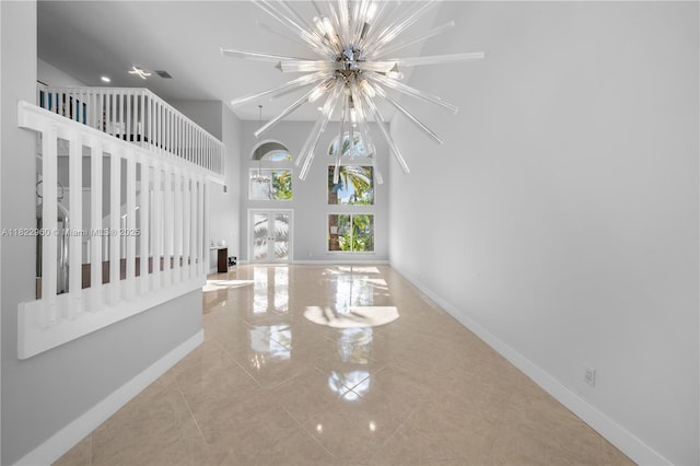 2631 SW 180th Ave, Miramar, FL 33029 - unfurnished living room with a chandelier, tile patterned flooring, and a high ceiling