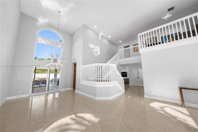 2631 SW 180th Ave, Miramar, FL 33029 - unfurnished living room featuring a high ceiling, plenty of natural light, stairs, and recessed lighting