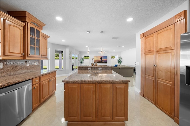 2631 SW 180th Ave, Miramar, FL 33029 - kitchen with appliances with stainless steel finishes, open floor plan, a kitchen island, glass insert cabinets, and dark stone counters