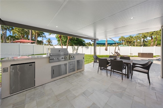 2631 SW 180th Ave, Miramar, FL 33029 - fenced backyard with a hot tub, outdoor dining space, a patio area, and an outdoor kitchen