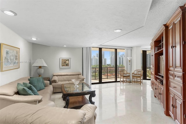 19667 Turnberry Way Unit 6-A, Aventura, FL 33180 - living room with floor to ceiling windows, recessed lighting, a textured ceiling, and light marble finish floors