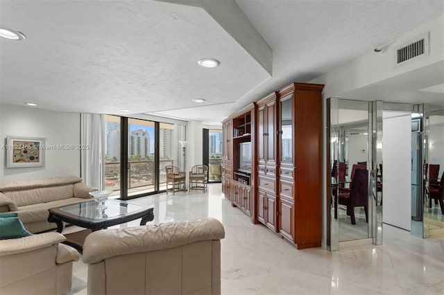 19667 Turnberry Way Unit 6-A, Aventura, FL 33180 - living room with a textured ceiling, expansive windows, and recessed lighting