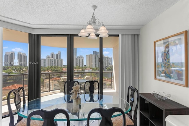 19667 Turnberry Way Unit 6-A, Aventura, FL 33180 - dining space featuring a chandelier, a view of skyline, and a textured ceiling