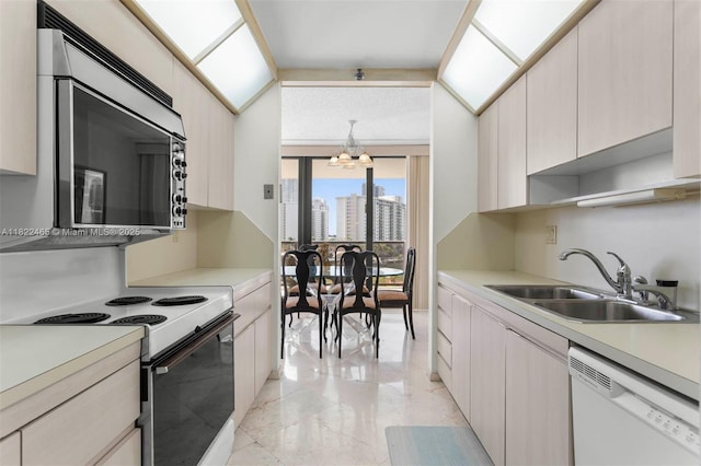 19667 Turnberry Way Unit 6-A, Aventura, FL 33180 - kitchen featuring white appliances, a chandelier, light countertops, and light marble finish flooring