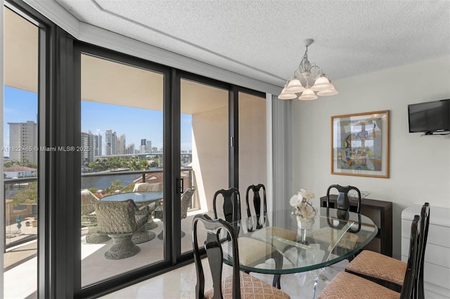 19667 Turnberry Way Unit 6-A, Aventura, FL 33180 - dining area featuring a chandelier, a view of skyline, and a textured ceiling