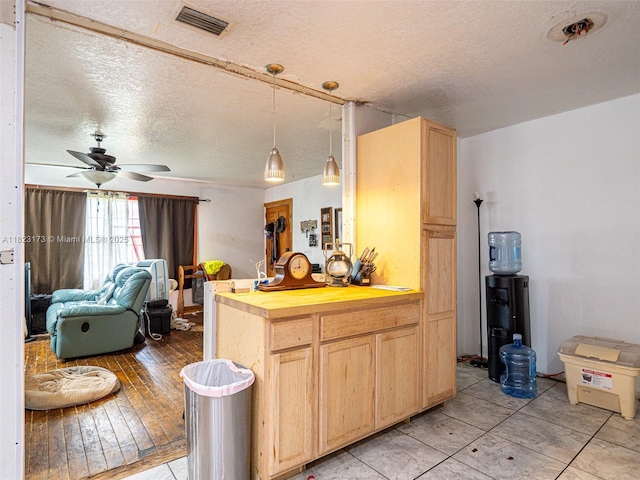 907 S Amelia Ave, Deltona, FL 32724 - kitchen featuring light brown cabinetry, wooden counters, a textured ceiling, open floor plan, and ceiling fan