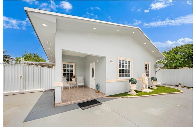 611 E 48th St, Hialeah, FL 33013 - back of house with stucco siding and a patio area