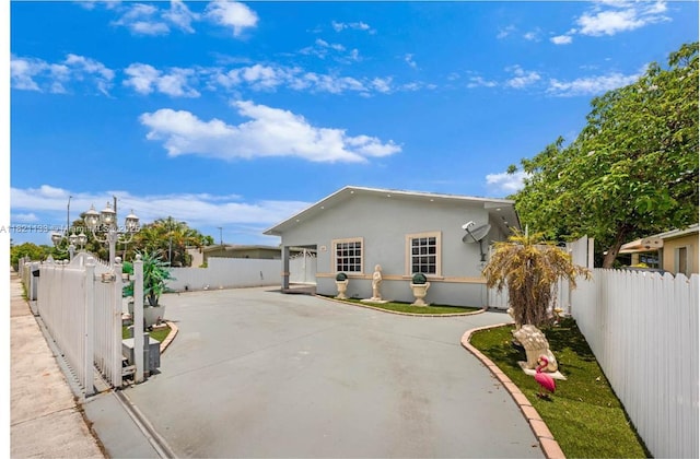 611 E 48th St, Hialeah, FL 33013 - view of front facade featuring stucco siding and a fenced backyard