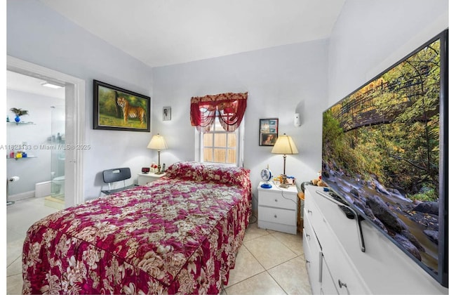 611 E 48th St, Hialeah, FL 33013 - bedroom featuring light tile patterned floors and ensuite bath