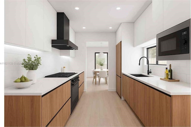 611 E 48th St, Hialeah, FL 33013 - kitchen with wall chimney exhaust hood, black appliances, modern cabinets, backsplash, and light countertops