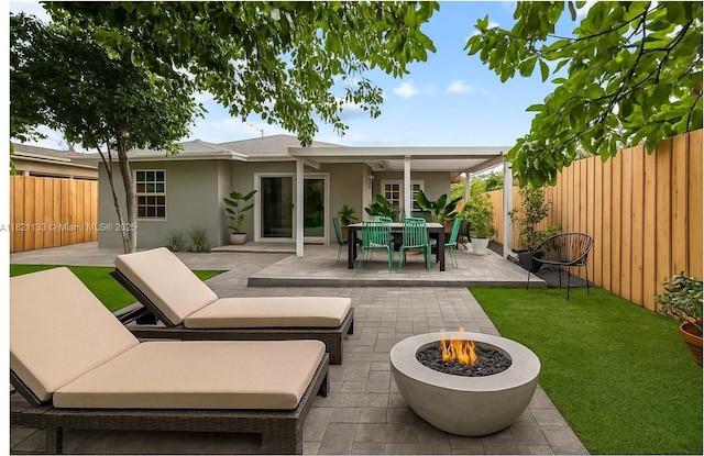 611 E 48th St, Hialeah, FL 33013 - fenced backyard with an outdoor fire pit, a patio, and outdoor dining area