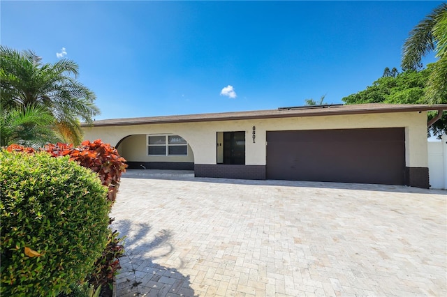 8801 NW 5th St, Pembroke Pines, FL 33024 - ranch-style home with a garage, stucco siding, roof mounted solar panels, and driveway
