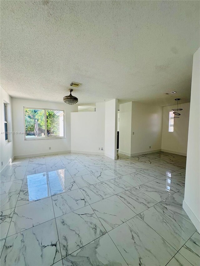 18961 NW 22nd St, Pembroke Pines, FL 33029 - unfurnished room featuring light marble finish flooring and a textured ceiling