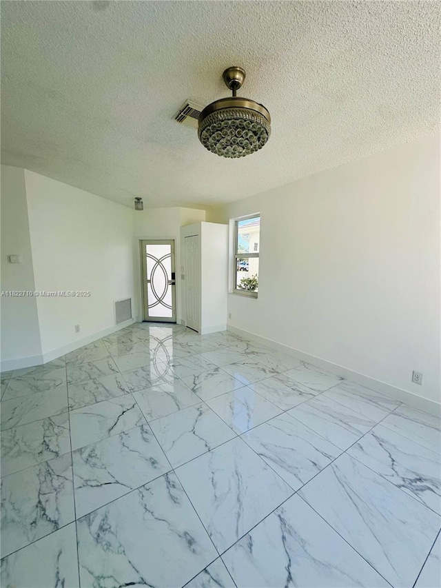 18961 NW 22nd St, Pembroke Pines, FL 33029 - unfurnished room featuring a textured ceiling and light marble finish flooring