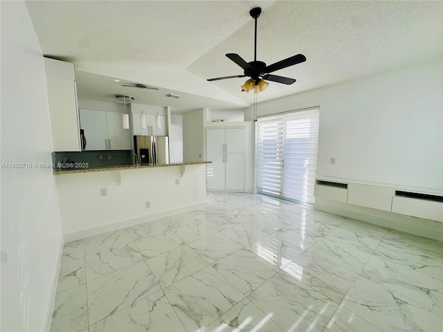 18961 NW 22nd St, Pembroke Pines, FL 33029 - unfurnished living room with ceiling fan, light marble finish floors, a textured ceiling, and vaulted ceiling