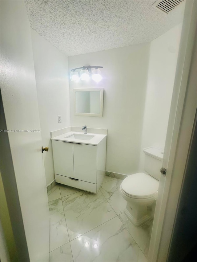 18961 NW 22nd St, Pembroke Pines, FL 33029 - bathroom with vanity, marble look tiles, and a textured ceiling