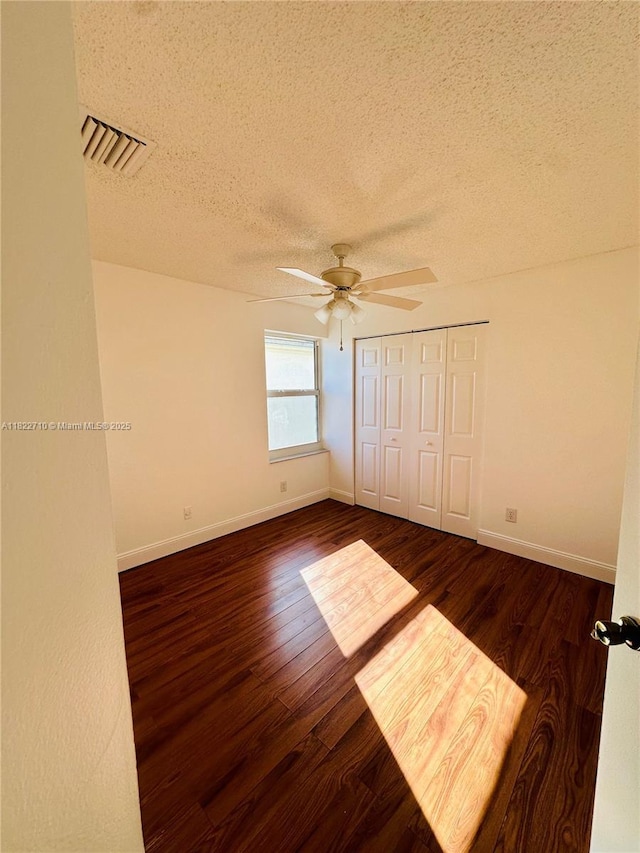 18961 NW 22nd St, Pembroke Pines, FL 33029 - unfurnished bedroom featuring a textured ceiling, dark wood-style flooring, ceiling fan, and a closet