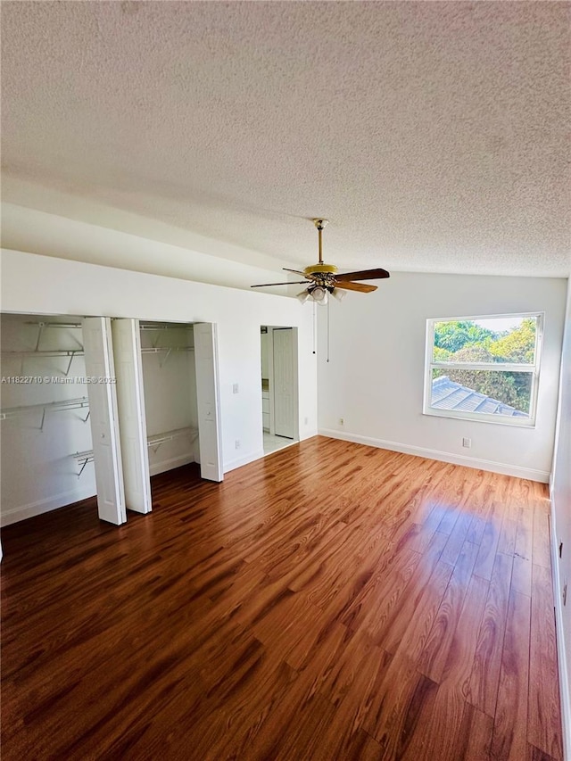 18961 NW 22nd St, Pembroke Pines, FL 33029 - unfurnished bedroom with a textured ceiling, wood finished floors, two closets, and a ceiling fan