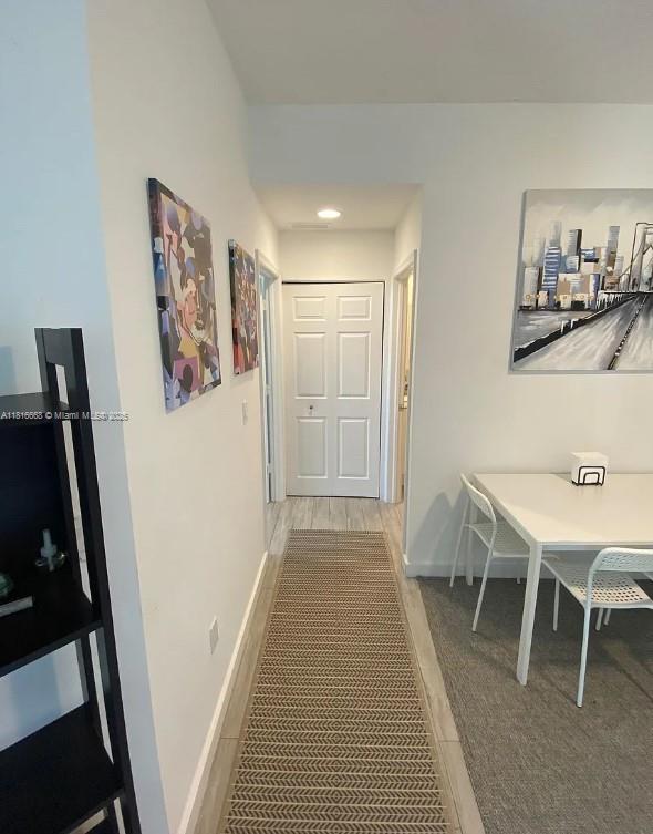 275 NE 18th St Unit 402, Miami, FL 33132 - hallway featuring baseboards