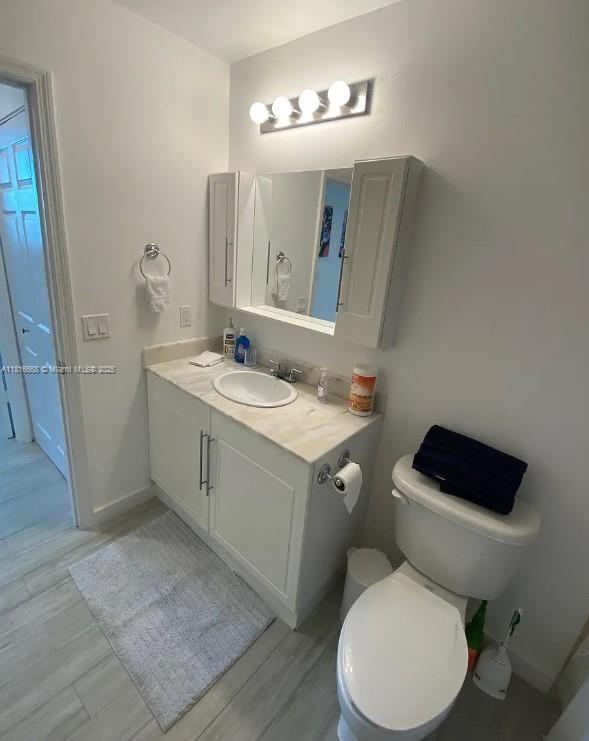 275 NE 18th St Unit 402, Miami, FL 33132 - half bath with vanity and wood finished floors