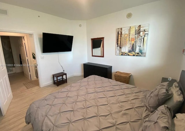 275 NE 18th St Unit 402, Miami, FL 33132 - bedroom featuring wood finished floors and baseboards