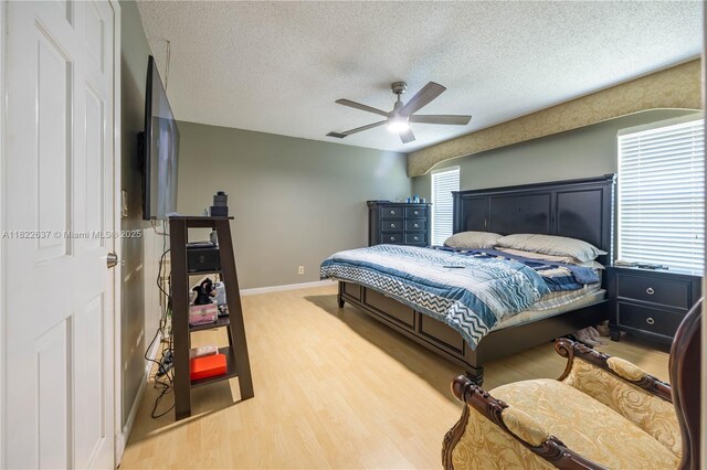 11351 NW 37th St, Coral Springs, FL 33065 - bedroom with a textured ceiling, wood finished floors, and a ceiling fan