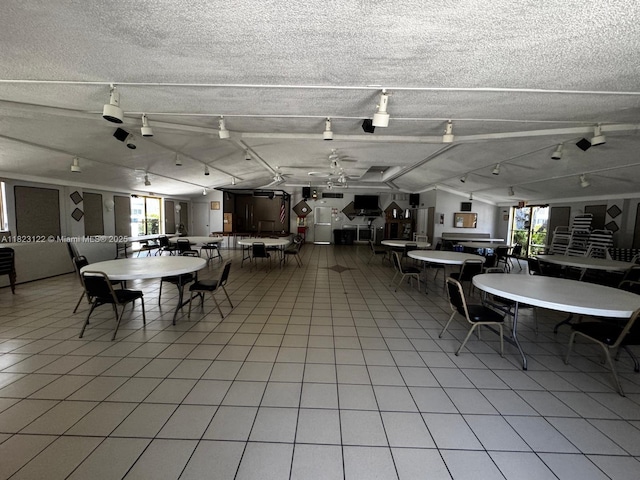 215 SE 3rd Ave Unit 405C, Hallandale Beach, FL 33009 - dining space featuring lofted ceiling, a textured ceiling, and light tile patterned floors