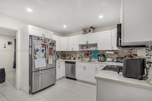 114 Marion Rd, West Park, FL 33023 - kitchen with stainless steel appliances, tasteful backsplash, white cabinetry, light tile patterned floors, and light stone counters