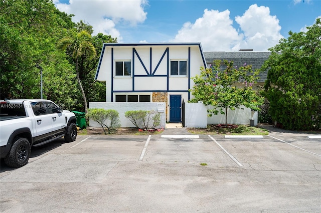 6797 SW 40th St Unit 71, Davie, FL 33314 - view of front facade featuring uncovered parking, stucco siding, and a shingled roof