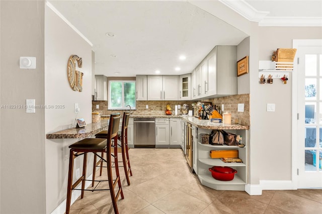 6797 SW 40th St Unit 71, Davie, FL 33314 - kitchen with dishwasher, tasteful backsplash, light stone counters, a breakfast bar area, and crown molding
