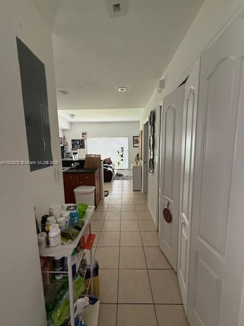 8960 W Flagler St Unit 1, Miami, FL 33174 - hallway featuring light tile patterned floors and electric panel