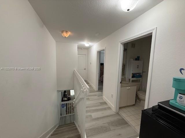 8960 W Flagler St Unit 1, Miami, FL 33174 - hallway featuring an upstairs landing and baseboards