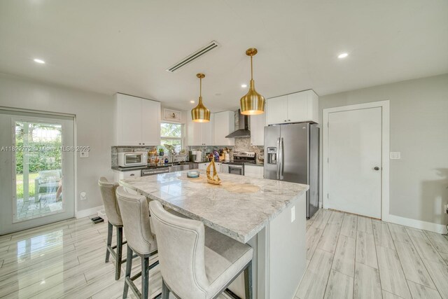 9104 SW 180th St, Palmetto Bay, FL 33157 - kitchen featuring stainless steel appliances, wall chimney exhaust hood, backsplash, a kitchen island, and recessed lighting