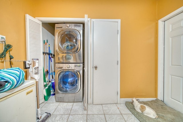 9104 SW 180th St, Palmetto Bay, FL 33157 - laundry area with stacked washer / dryer and light tile patterned flooring