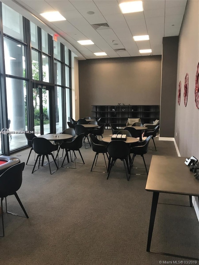 1600 NE 1st Ave Unit 1611, Miami, FL 33132 - carpeted dining space with a wall of windows