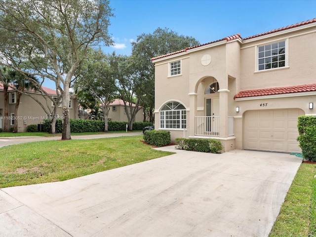 457 NW 87th Ln, Coral Springs, FL 33071 - mediterranean / spanish house featuring an attached garage, a tile roof, driveway, stucco siding, and a front yard