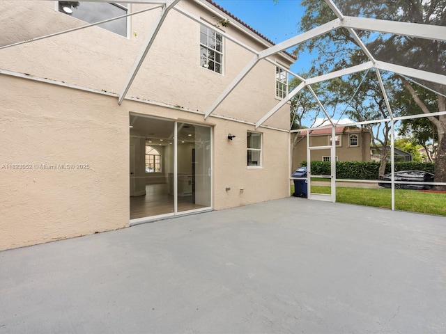 457 NW 87th Ln, Coral Springs, FL 33071 - rear view of house featuring stucco siding, a patio area, and a lanai