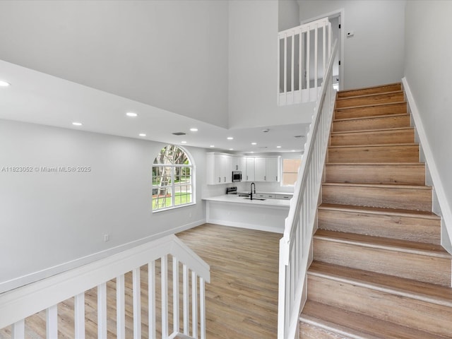 457 NW 87th Ln, Coral Springs, FL 33071 - stairway featuring recessed lighting and wood finished floors