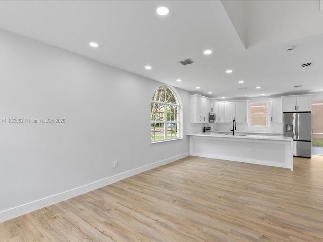 457 NW 87th Ln, Coral Springs, FL 33071 - kitchen featuring appliances with stainless steel finishes, light countertops, a peninsula, recessed lighting, and light wood finished floors