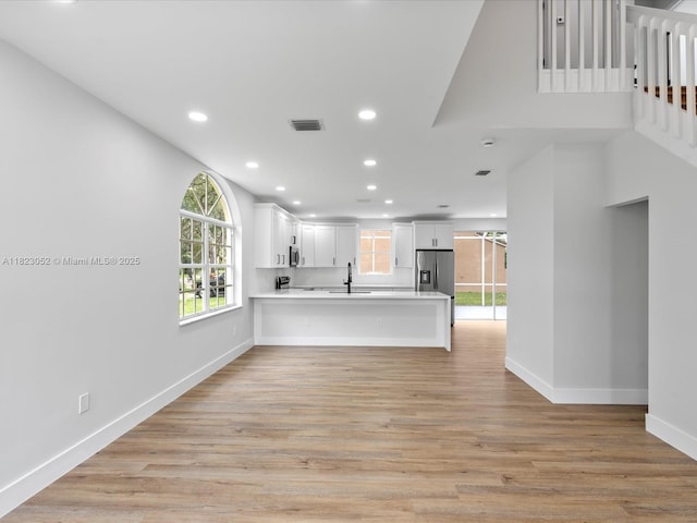 457 NW 87th Ln, Coral Springs, FL 33071 - kitchen with appliances with stainless steel finishes, light countertops, a peninsula, open floor plan, and recessed lighting