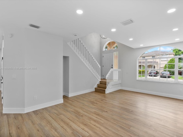 457 NW 87th Ln, Coral Springs, FL 33071 - unfurnished living room with light wood-style floors, stairway, recessed lighting, and vaulted ceiling