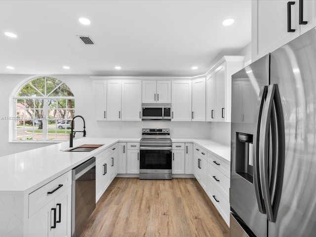 457 NW 87th Ln, Coral Springs, FL 33071 - kitchen featuring stainless steel appliances, light wood-style floors, light countertops, a peninsula, and recessed lighting