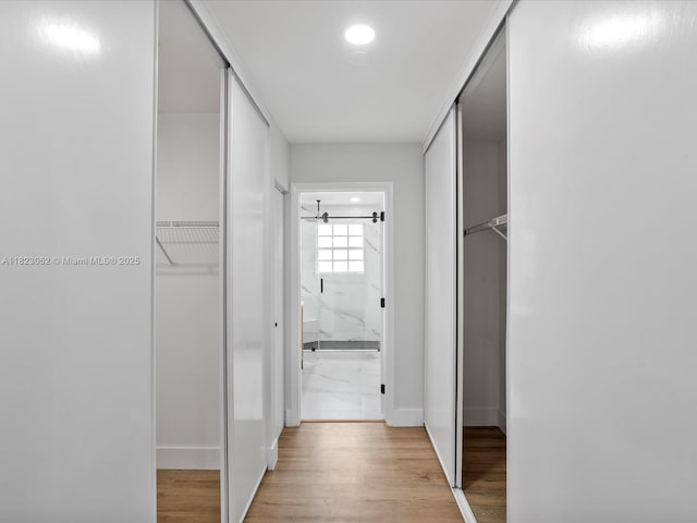 457 NW 87th Ln, Coral Springs, FL 33071 - corridor featuring light wood finished floors and baseboards