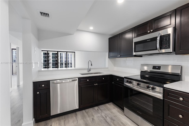 555 NE 15th St Unit 29F, Miami, FL 33132 - kitchen with appliances with stainless steel finishes, light wood-style flooring, backsplash, light countertops, and recessed lighting