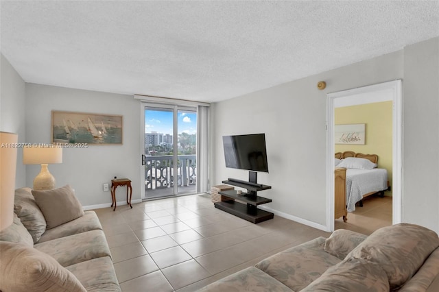 1020 Meridian Ave Unit 616, Miami Beach, FL 33139 - tiled living room featuring a textured ceiling and baseboards