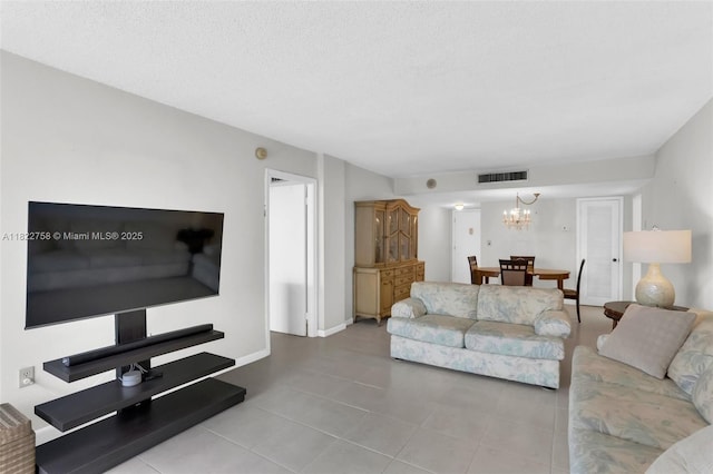 1020 Meridian Ave Unit 616, Miami Beach, FL 33139 - living room with tile patterned floors, a chandelier, and a textured ceiling