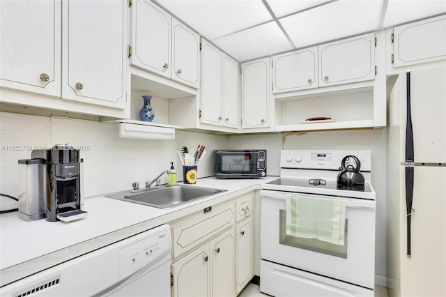 1020 Meridian Ave Unit 616, Miami Beach, FL 33139 - kitchen with white appliances, open shelves, light countertops, white cabinets, and a paneled ceiling