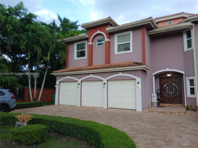 13190 NW 6th St, Miami, FL 33182 - mediterranean / spanish-style house with decorative driveway, stucco siding, a garage, and a tiled roof