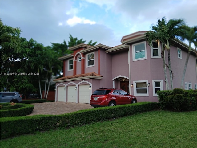 13190 NW 6th St, Miami, FL 33182 - view of front of property featuring stucco siding, driveway, a front yard, and a garage
