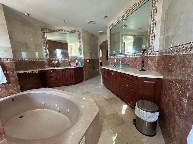 13190 NW 6th St, Miami, FL 33182 - bathroom featuring tile walls, a whirlpool tub, vanity, and tile patterned flooring